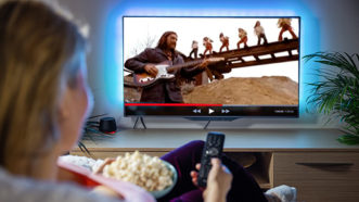 Norman Greenbaum with electric guitar in Spirit In The Sky video with backup gospel singers on TV screen in commercials.